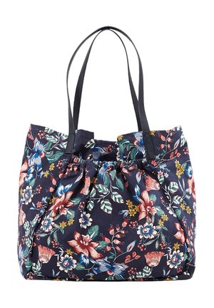 Sac fourre-tout en tissu bleu marine avec imprimé floral multicolore et deux bretelles noires.
