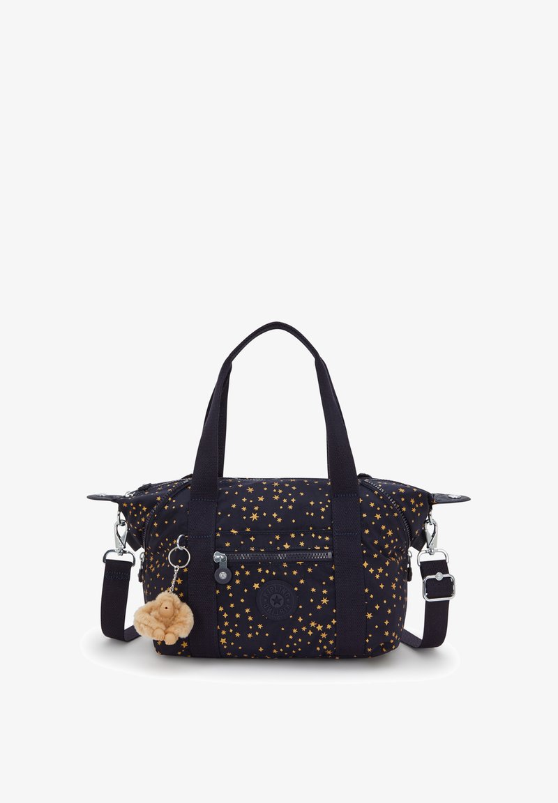 Schwarze Stofftasche mit goldenem Sternmuster, zwei oberen Griffen, abnehmbarem Schultergurt, Reißverschluss und einem flauschigen Schlüsselanhänger.