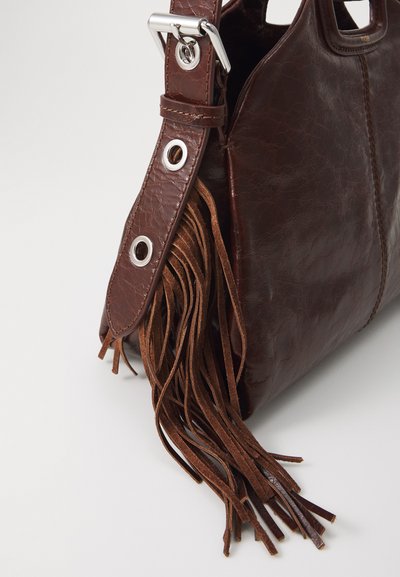 Brown leather handbag with a textured finish, featuring a strap with metal hardware and long leather tassels.