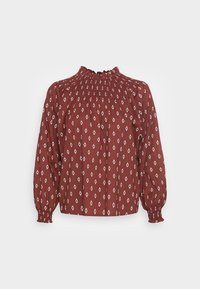 Burgundy paita avec un motif de diamants blancs, encolure smockée, longues manches bouffantes et poignets élastiques. Tissu léger avec une finition texturée.