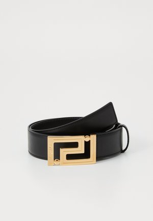 Black leather belt featuring a gold geometric buckle with a distinctive design. Smooth texture with contrasting finishes on the buckle.