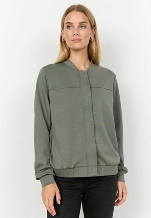 Olive green bomber jacket in soft fabric, featuring a round neckline, front closure, and ribbed cuffs and hem. Simple, streamlined design.