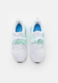 White athletic shoes with light green accents, a mesh upper, and a textured pattern. Features laces and blue inner lining.