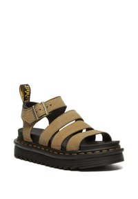 Sandalo in pelle marrone con tre ampie cinghie, fibbia regolabile e suola in gomma nera con cuciture gialle e un'etichetta in tessuto.