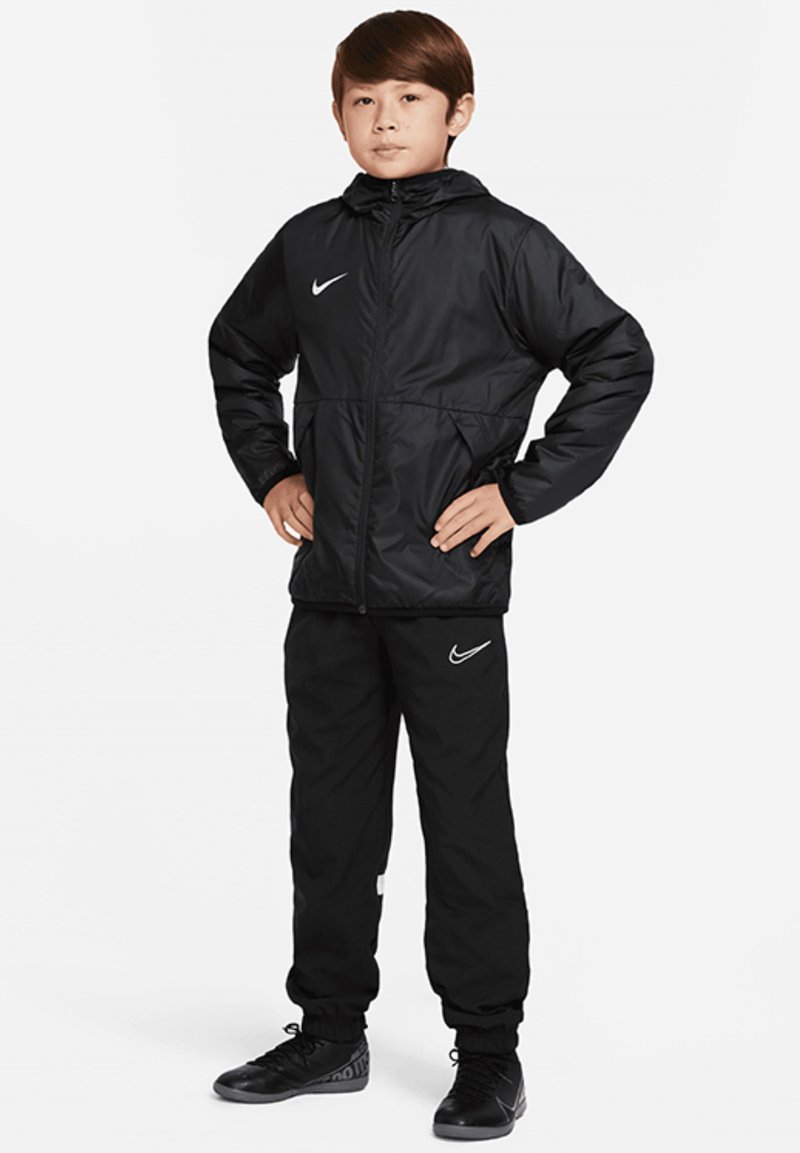 Veste de sport noire Nike avec capuche, poignets élastiques et fermeture éclair, associée à un pantalon de jogging assorti, arborant le logo Nike en blanc.