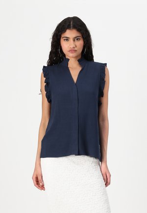Blouse sans manches bleu marine avec un décolleté en V et des épaules froncées. Fabriquée en tissu léger, avec un éclat subtil et une coupe décontractée.
