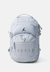 Light blue backpack with black accents, featuring a textured front pocket, zip closures, and the word "JORDAN" in a mesh detail.