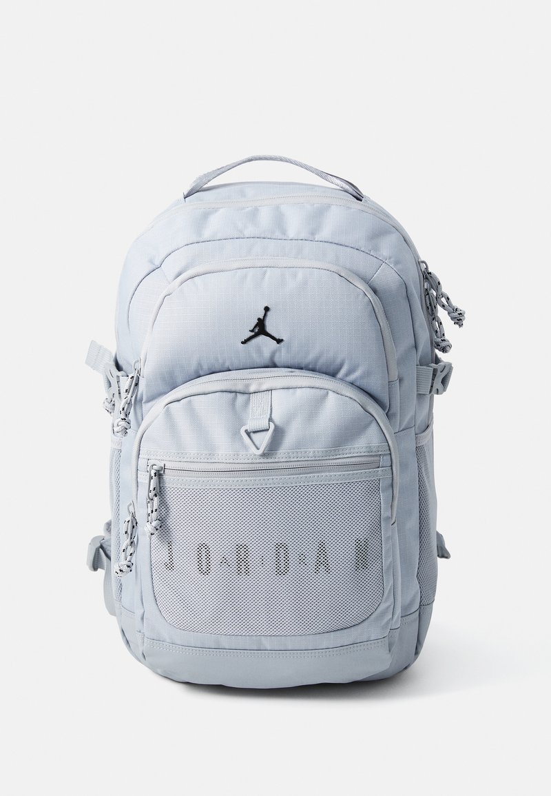 Light blue backpack with black accents, featuring a textured front pocket, zip closures, and the word "JORDAN" in a mesh detail.