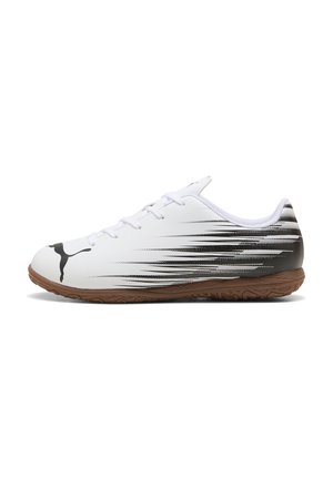 Weiße Sportlich-Schuhe mit schwarzen und grauen Geschwindigkeitsstreifen, strukturiertem Gummisohle und traditionellem Schnürsystem. Puma-Logo auf der Außenseite.