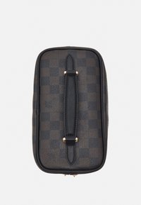 Black leather bag with checkerboard pattern, featuring a central strap, gold hardware accents, and a textured surface. Rectangular shape.