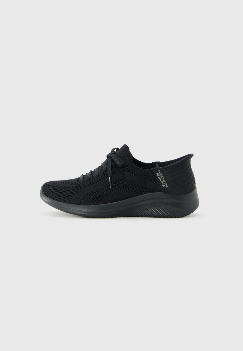 Black knit Skechers sneaker with lace-up front, textured heel, and thick sole shown from the side on a white background.