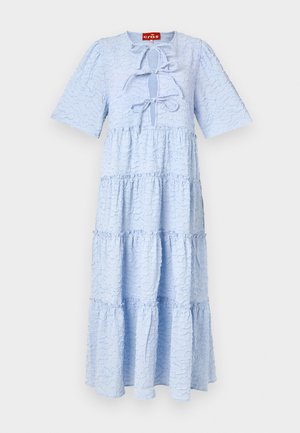 Lys blå lagdelt kjole laget av teksturert stoff med rund hals og korte ermer. Har en knytedetalj foran.