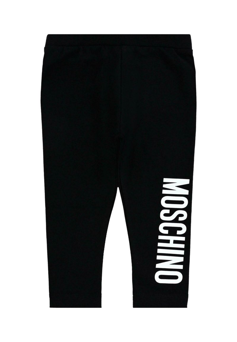 Czarne legginsy wykonane z elastycznego materiału o dopasowanym kroju. Posiadają dużą, białą grafikę z napisem "MOSCHINO" wydrukowanym pionowo na lewej nogawce.