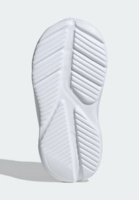 Semelle de chaussure de sport blanche en matériau en caoutchouc, présentant un motif de bande de roulement en zigzag et des sections lisses pour une traction et une flexibilité accrues.