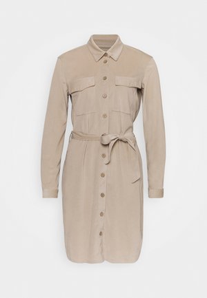 Beige long-sleeve shirt dress with front buttons, two chest pockets, collar, and tied waist belt.