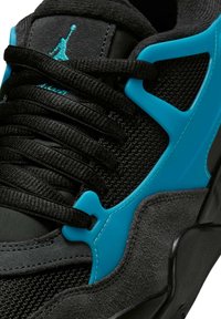 Czarny tenisówka z siateczkową cholewką z niebieskimi plastikowymi akcentami, okrągłymi sznurowadłami i czarną teksturowaną podeszwą. Projekt zawiera panel z zamszu.