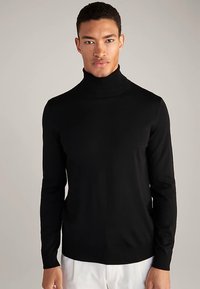 Fekete garbó pulóver, testhezálló kialakítással, sima kötött anyagból. Hosszú ujjú, bordázott gallérral és szegéllyel.