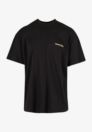 Fekete pamut póló kerek nyakkivágással, rövid ujjakkal és egy kis arany logóval a bal mellen. Lazán illeszkedő, sima textúrájú.