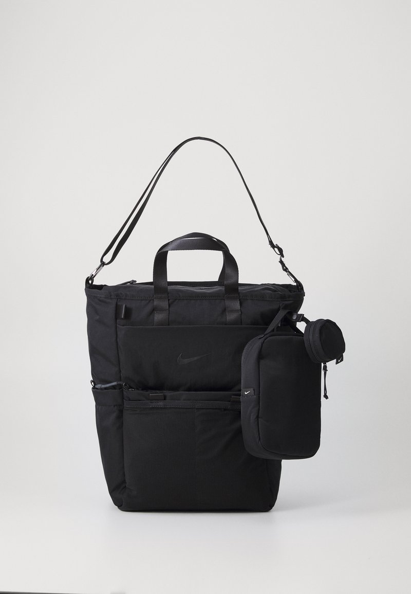 Saco tote preto em nylon com alças duplas e tira de ombro ajustável, apresentando vários bolsos com fecho éclair e uma bolsa destacável.
