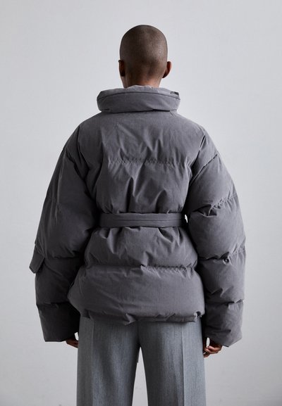 Gray puffer jacket with a high collar, belted waist, and oversized sleeves. The fabric appears textured with a subtle sheen.