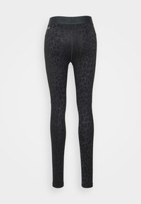Leggings neri con un sottile motivo a stampa leopardata, dotati di una vita alta e di una vestibilità aderente e elastica su tutta la lunghezza delle gambe.