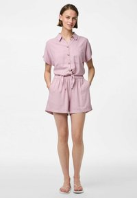 Jumpsuit rose clair à manches courtes avec un devant boutonné, une taille élastique et des poches. Fabriqué dans un tissu respirant avec une coupe décontractée.