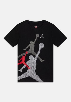 Sort t-shirt med korte ærmer med tre Jumpman basketballspiller-silhuetter i rød, sølv og grå på fronten.