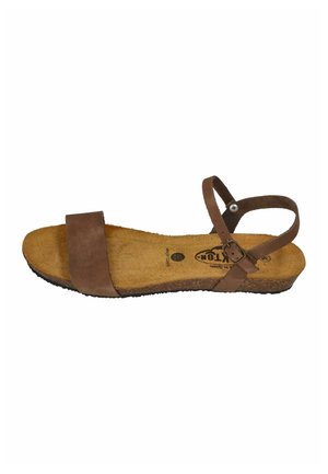 Brown flat sandal with wide front strap, adjustable ankle strap with buckle, cork sole, and soft footbed.