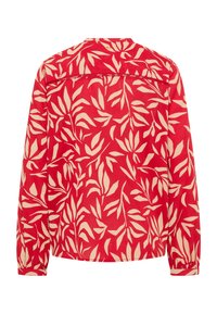 Chemise rouge à manches longues avec un motif de feuilles crème, présentant un col rond, des poignets élastiqués et un empiècement dans le dos.