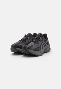 Baskets de sport noires avec un dessus en mesh respirant, des motifs texturés, un bout rond et une semelle épaisse et rembourrée pour le soutien.