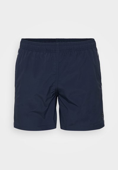 T tumšo jūras zils peldbikses ar elastīgu jostasvietu, divām sānu kabatām un pogu detaļu kreisajā kājā. Viegls, gluds audums.