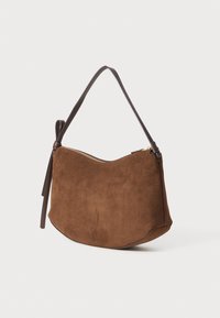 Brown suede shoulder bag with a curved silhouette, featuring a brown leather strap and a zipper closure, smooth texture, and simple design.