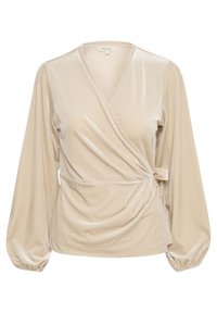 Top envolvente beige en suave terciopelo texturizado, con mangas largas abullonadas, un escote en V profundo y un lazo lateral para una silueta ajustada.