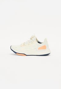 Lightweight athletic shoe in cream color with mesh upper, contrasting navy and coral accents, textured sole, and standard lace closure.