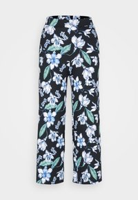 Pantalons floraux avec un fond noir, ornés de grandes fleurs blanches et bleues, accompagnées de feuilles vertes. Design ample et large.