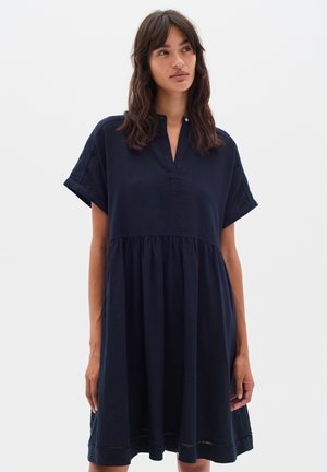Navy blue linen dress with a gathered skirt, short sleeves, and a subtle notch collar. Features a loose fit and delicate hem detailing.
