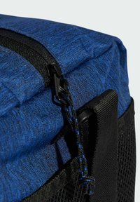 Blue fabric bag with a textured surface, featuring a black zipper, mesh side pocket, and contrasting braided cord detail.