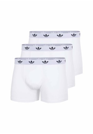 Tre boxer bianchi con fascia elastica grigia con loghi neri Adidas trefoil ripetuti.