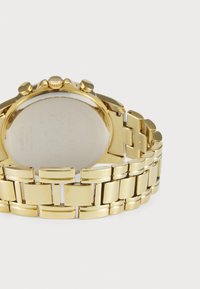 Gold-tone metal watch with a polished bracelet, round case, and chronograph sub-dials. Smooth back, rectangular link design.