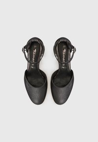 Black slingback shoes with a smooth, shimmering finish. Open toe design and thin ankle strap featuring a silver buckle. Size 37.