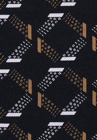 Patterned fabric featuring geometric shapes in white, brown, and gold on a black background, with a textured weave that enhances depth.