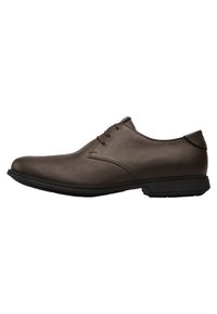 Brown leather dress shoe with a smooth texture, round toe, lace-up design, and a black rubber sole. No visible patterns or accents.