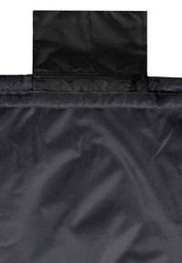 Černá nylonová tkanina se hladkým povrchem, vybavená zipem na vrchu a skládacím designem pro kompaktní úložiště.