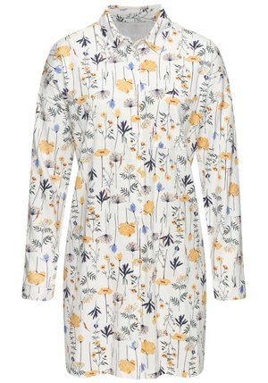 Skjorta med blommigt mönster som har en vit bakgrund med gula, blå och svarta blommor. Långa ärmar, knäppning framtill och fickdetalj.