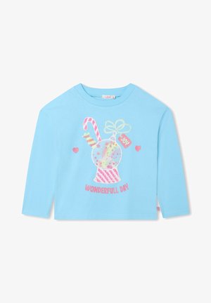 Chemise bleu clair à manches longues avec un sucre d'orge pailleté, un ornement, un nœud, des cœurs et le texte « Wonderful Day » sur le devant.