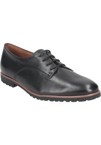 Scarpa nera in pelle con lacci e punta arrotondata, caratterizzata da una superficie liscia, suola marrone a contrasto e leggero battistrada per una buona aderenza.