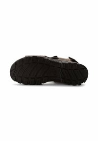 Schuhe mit einer schwarzen Gummisohle, strukturiertem Profil, leichtem braunen Obermaterial und Klettverschluss. Das Design ist praktisch und langlebig.