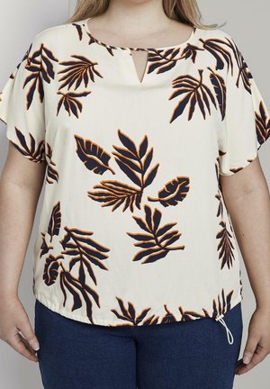 Lys beige bluse med marineblå bladprint, har en nøglehuludskæring og korte ærmer. Bunden har en justerbar snor.