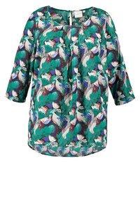 Blouse ample à manches trois-quarts avec un motif botanique coloré aux tons verts, violets, blancs et rouges.