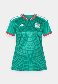 Green soccer jersey featuring intricate patterns, white and red accents, V-neck design, and a logo on the chest. Made from breathable material.